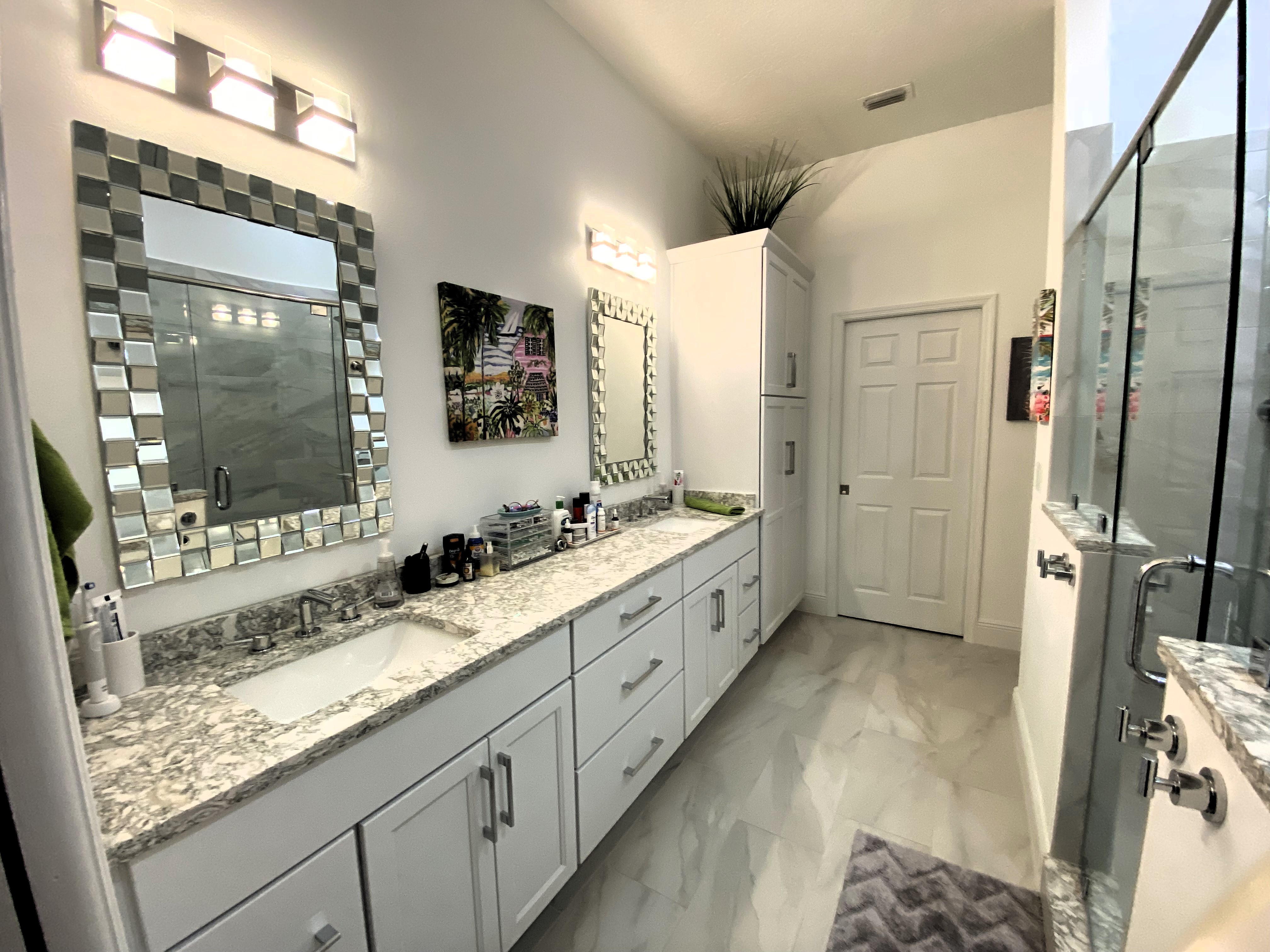 Large bathroom featuring semi-custom maple painted cabinetry with chrome hardware and Cambria quartz countertops with matching 4" backsplash.