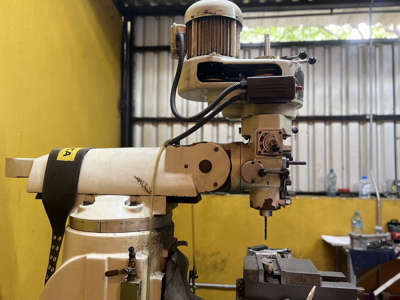 Close-up of a CNC laser cutting machine processing metal with sparks flying in a modern industrial workshop.