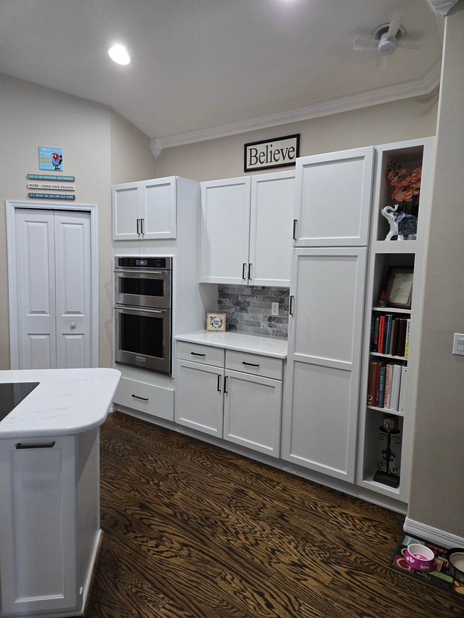 Beautiful semi-custom cabinetry with a seamless built-in aesthetic offering generous storage, a cozy book nook, and a versatile coffee or cocktail bar. 
