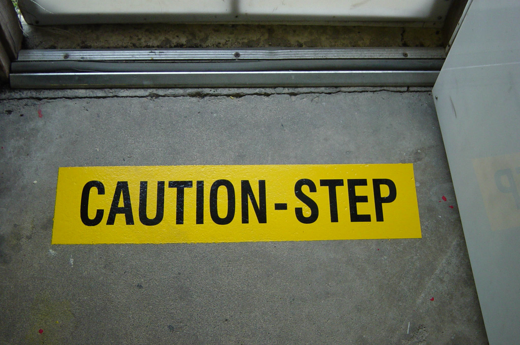 image of yellow box and black lettering painted using a 2-part paint mask stencil