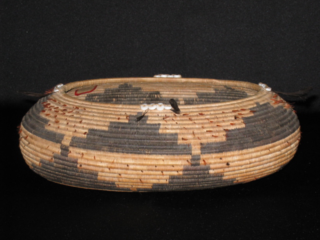 PRODUCT PROFILE :
Product No. : #70011
Description : Pomo Oval Basket
PRODUCT NARRATIVE :
• sedge and bulrush roots
• 3-rod will foundation
• black quail topknots, shell beads, read feathers
• size H. 4" Diam. 10" circa 1910