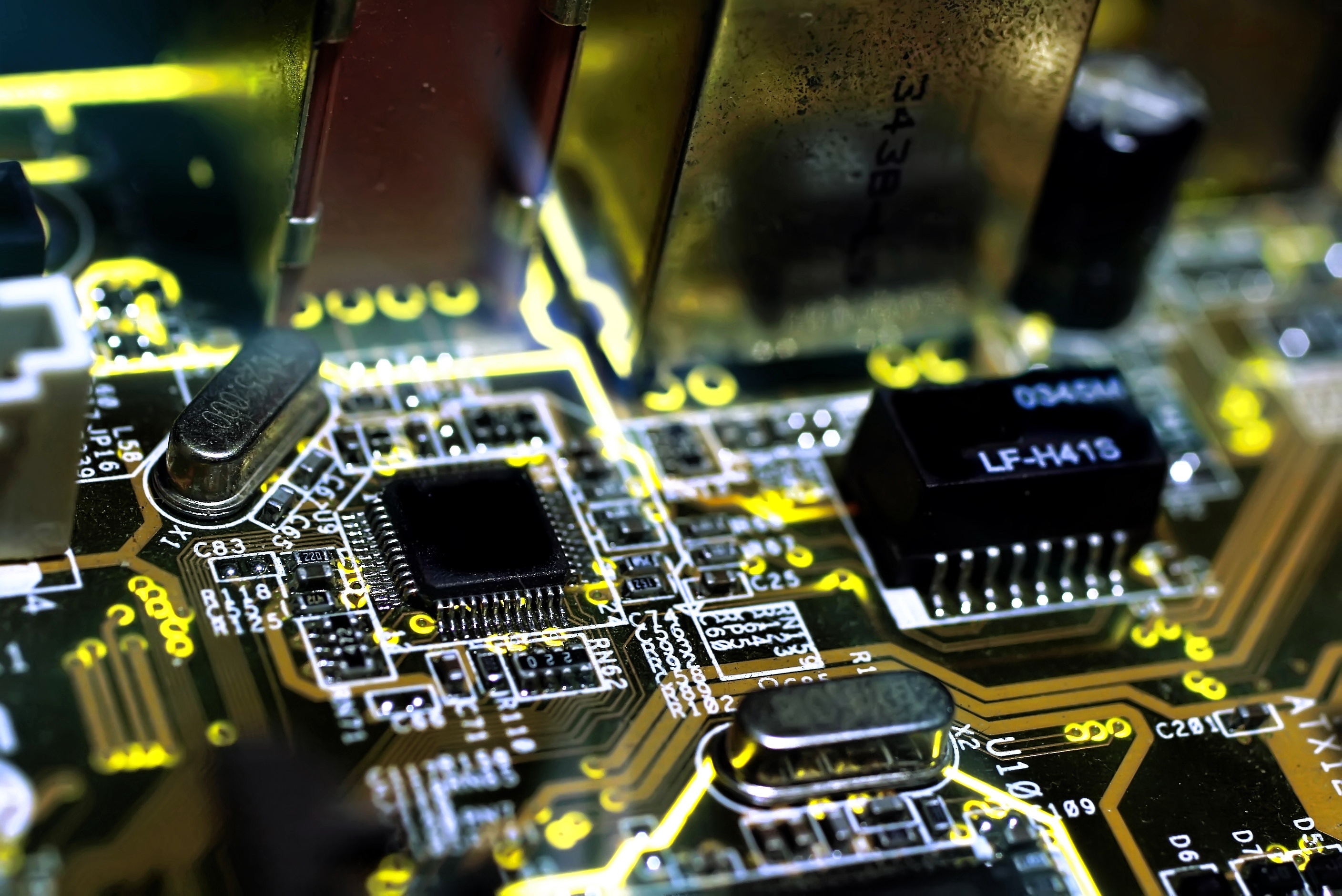 Close-up view of a computer motherboard with visible microchips and electronic components.