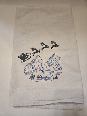 Flower sack towel featuring a Santa over house design