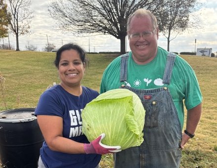 Vibrant farmers market display with fresh vegetables and fruits, including tomatoes, broccoli, peppers, and lettuce, with a vendor in the background. Vibrant farmers market display with fresh vegetables and fruits, including tomatoes, broccoli, peppers, and lettuce, with a vendor in the background.