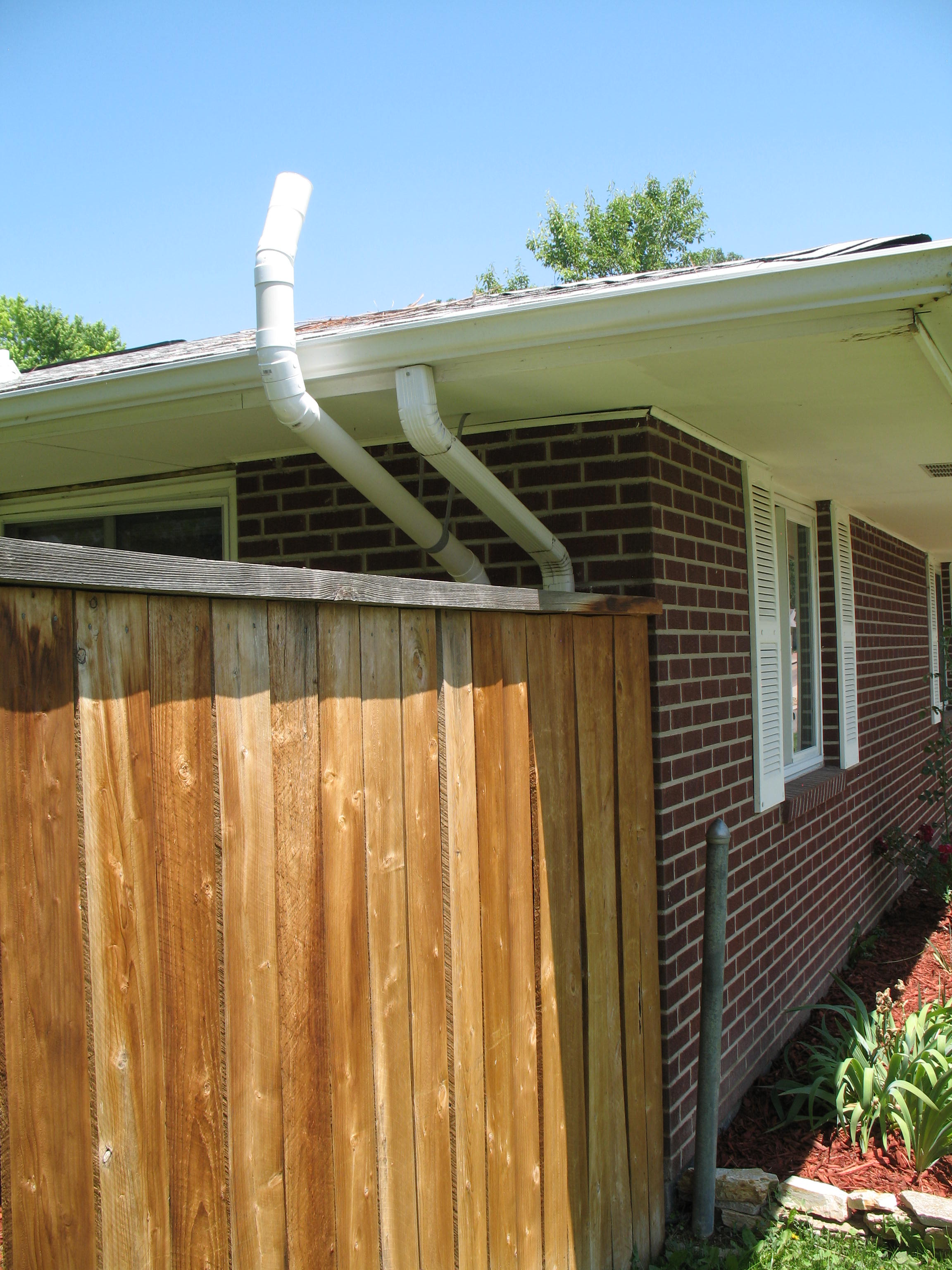 Outdoor system piped parallel to downspout