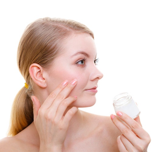 Woman Applying Face Cream with Her Finger