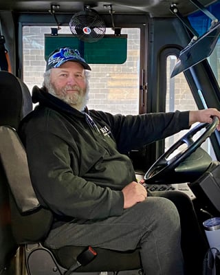Russell has always liked anything with an engine, so he started driving a big bus for us in January of 2020. Besides the good feeling of driving a bus, he really likes seeing the smiles and hearing the laughter of all the kids he brings to & from school.
When not driving, he likes to spend time at all the local car race tracks. And as you may of guessed, he’s a big Timberwolves fan!