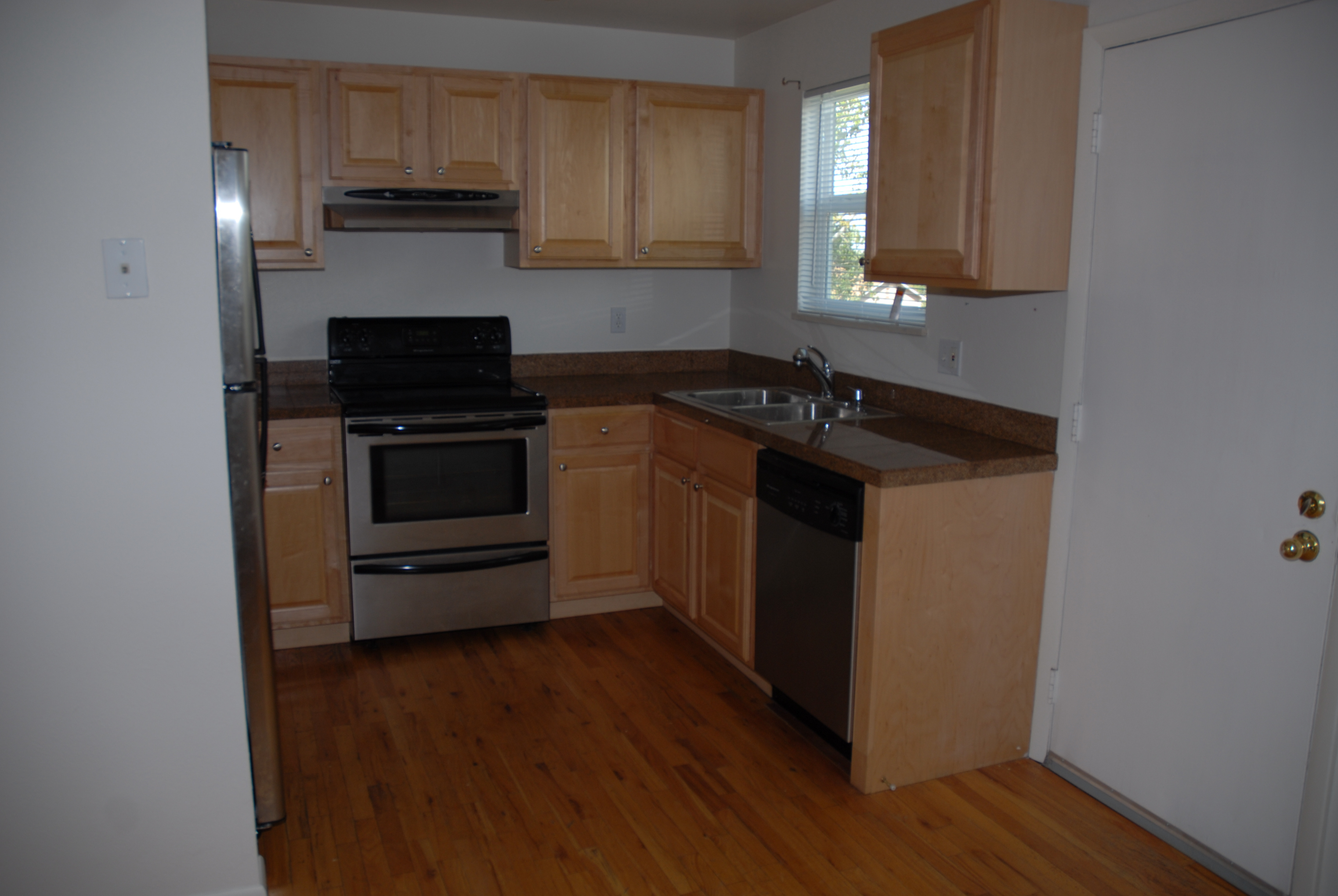 Kitchen with maple cabinets and hardwood floor.