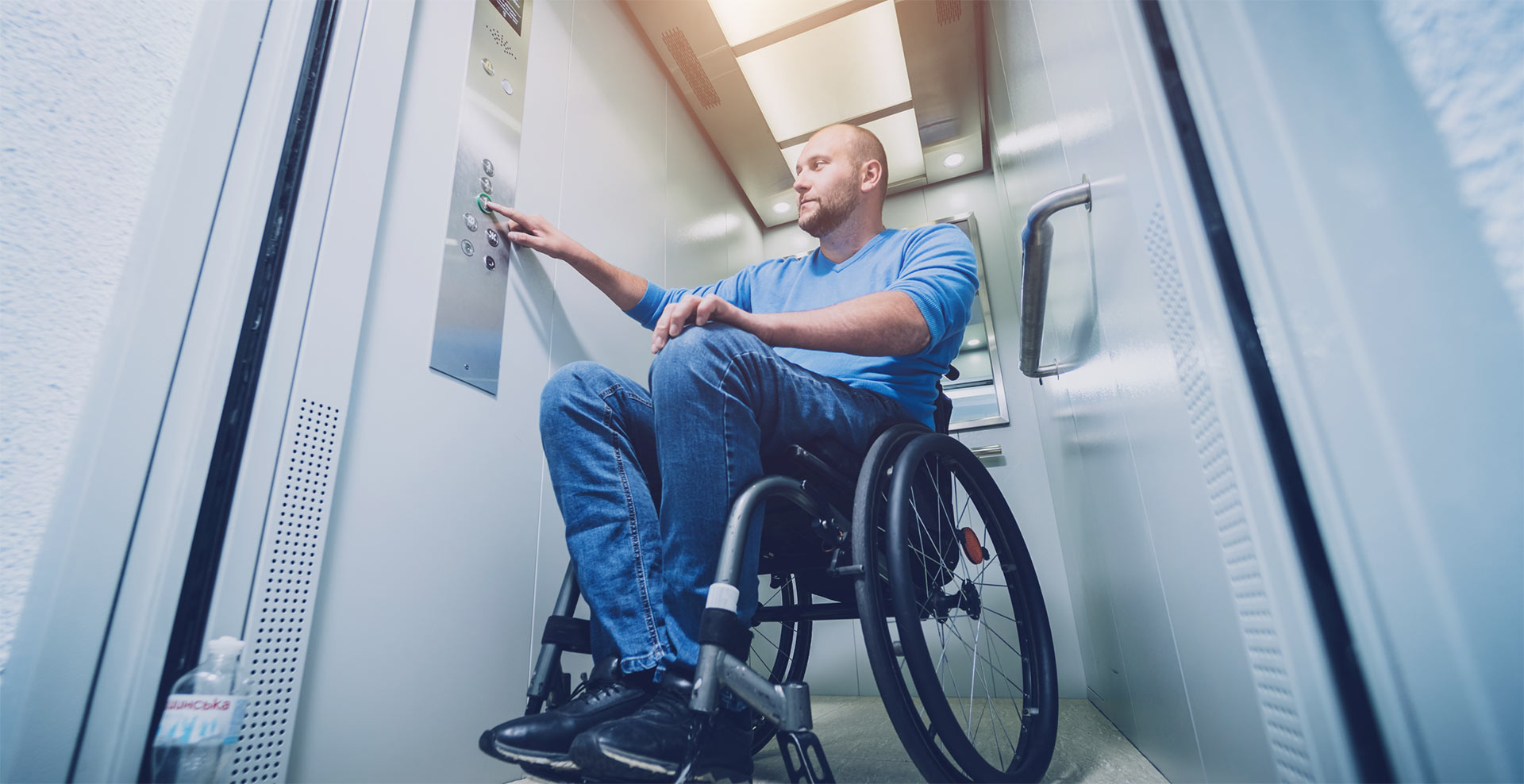 Disabled man in elevator Disabled man in elevator