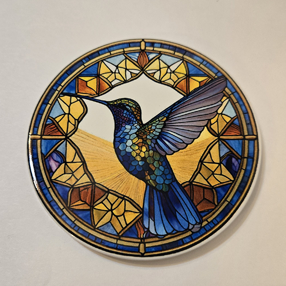 Round ceramic coaster with a stained glass hummingbird desing