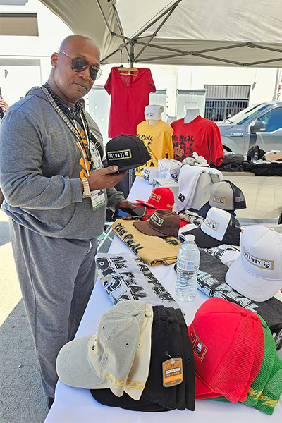 Man at the Rick Ross merch booth