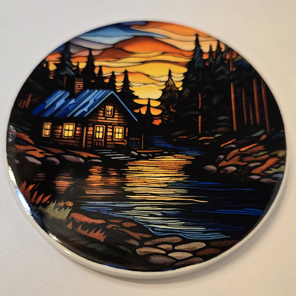 Round ceramic coaster with a stained glass cabin design