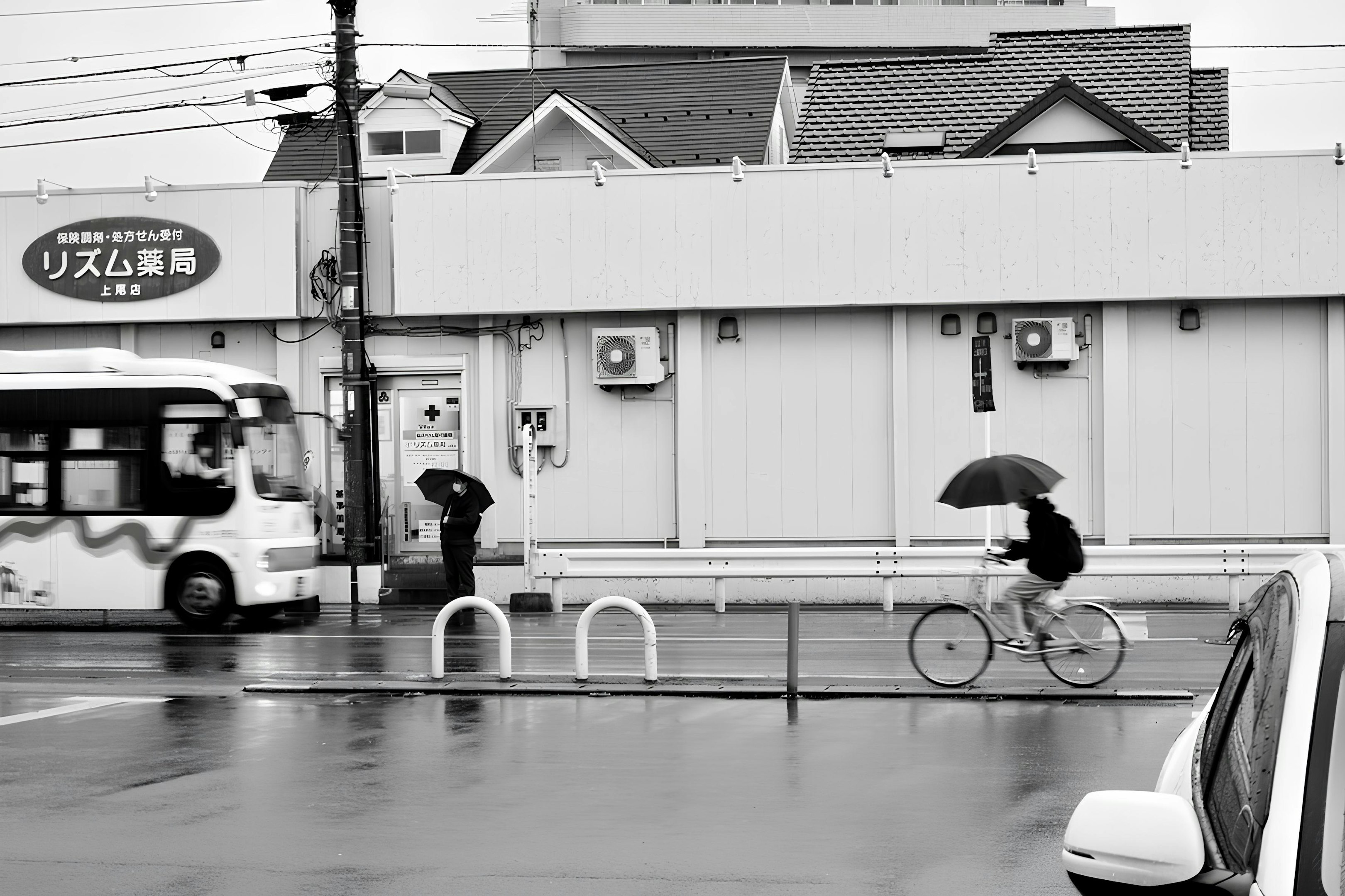 A black and white photo of a person with an umbrella