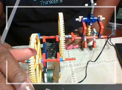 A student building a robot from plastic pieces
