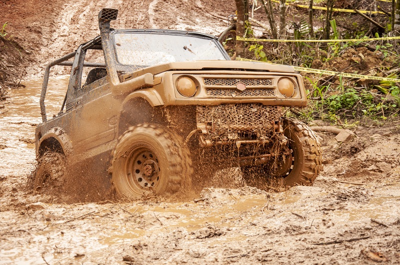 Jeep driving through mud