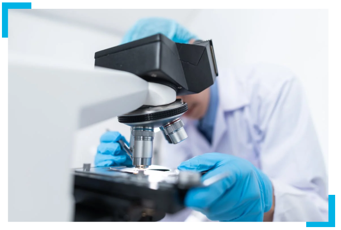 Lab Technician Using Microscope
