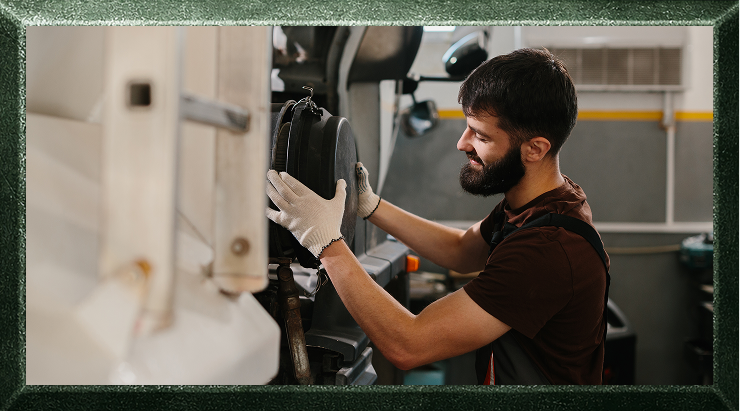Man repairing an RV tire in a shop.