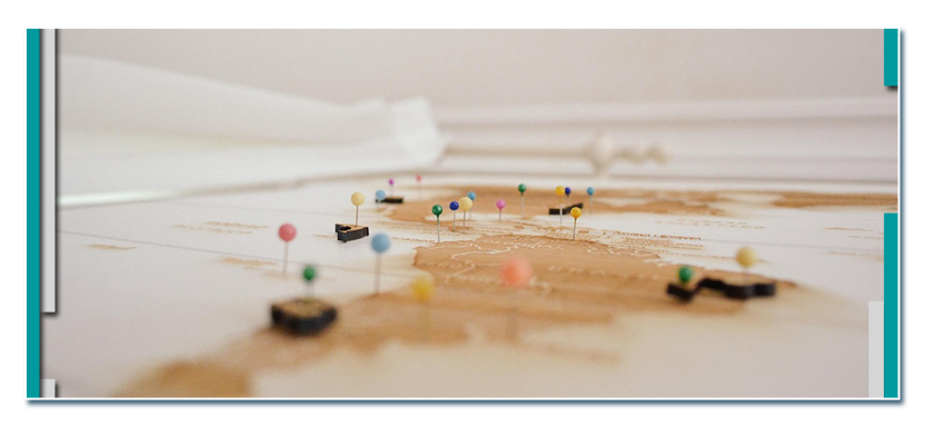 Several tacks pinned into a map