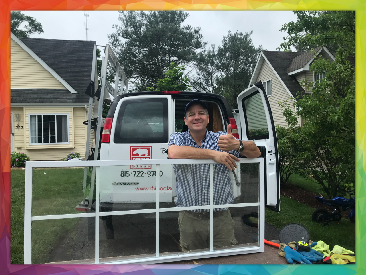 Modern living room with large windows overlooking a lush garden, featuring stylish furniture, a cozy fireplace, and wooden flooring.