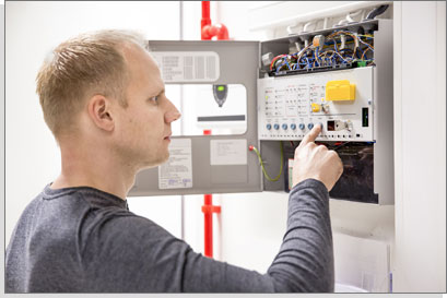 Technician Checks Fire Panel in Data Center