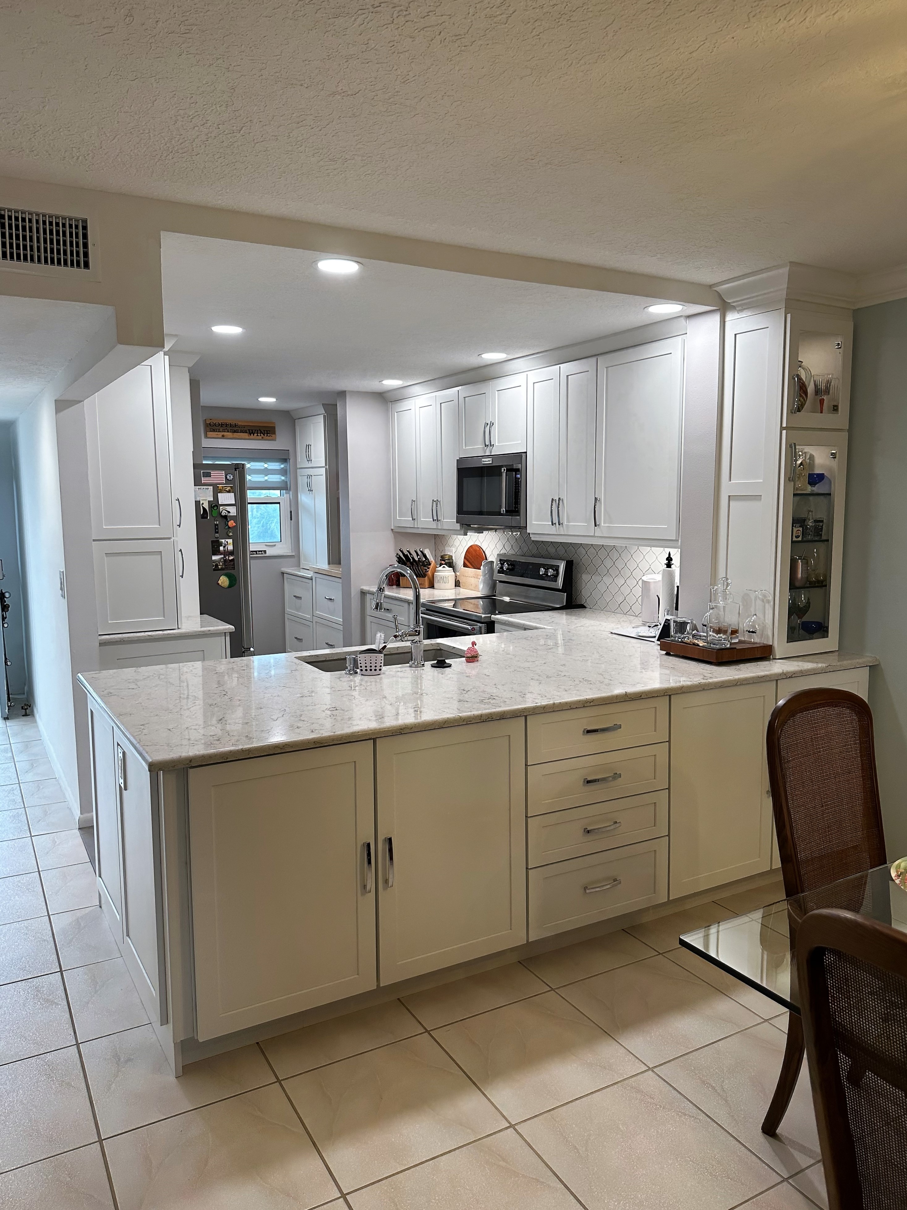 Beautiful kitchen featuring painted white cabinetry with satin nickel hardware.