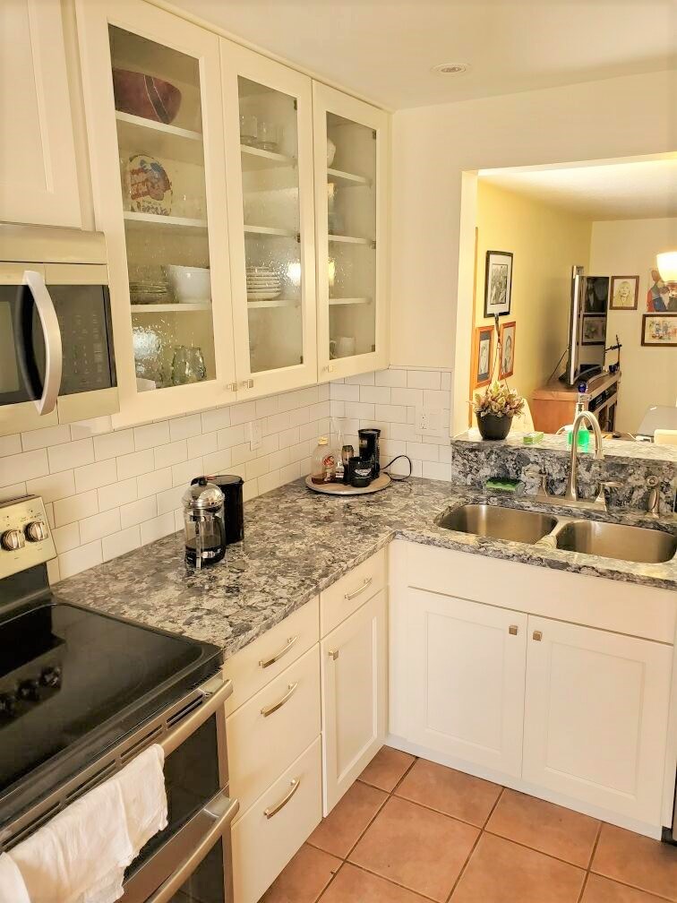 Classic kitchen featuring white subway tile backsplash and gorgeous countertops.
