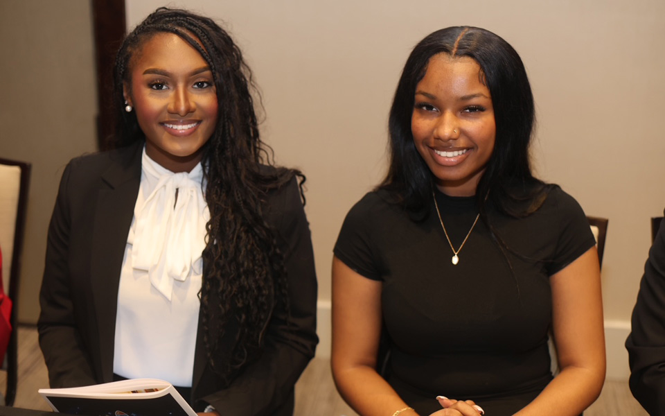Two attendees posing for a photo