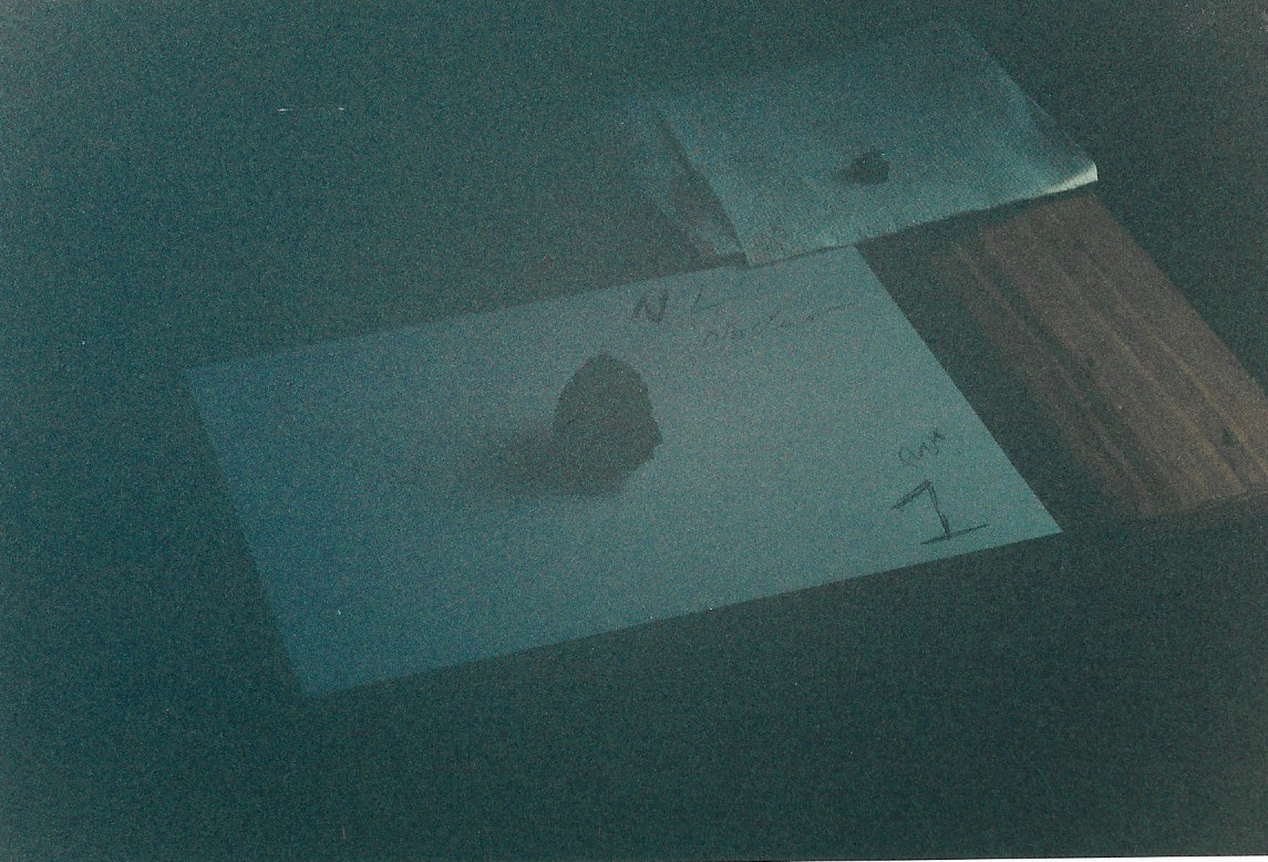 There is a lot of light from the sun shining into this room. To the right of this photo is a 5x4 foot 2 pane window. This window is on the opposite side of the gemstone shadow. The left side of this image is blacked out by the gemstone unidentified energy. There is a faint reddish color glow centered around the gemstone. The color of the desk top is true. The walls in this room is solid white. The object on the napkin in the upper right hand corner is a small bulk paper clip. The bottom of the image shows no color on the desk. This image was taken with a Minolta maxium 7000 AF with a telescopic lens maxxum 2000 AF 70-210 1:4(32)mm. There was damage to the camera electronics after taking these images. There is a lot of light from the sun shining into this room. To the right of this photo is a 5x4 foot 2 pane window. This window is on the opposite side of the gemstone shadow. The left side of this image is blacked out by the gemstone unidentified energy. There is a faint reddish color glow centered around the gemstone. The color of the desk top is true. The walls in this room is solid white. The object on the napkin in the upper right hand corner is a small bulk paper clip. The bottom of the image shows no color on the desk. This image was taken with a Minolta maxium 7000 AF with a telescopic lens maxxum 2000 AF 70-210 1:4(32)mm. There was damage to the camera electronics after taking these images.