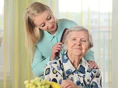 Senior Woman with Her Caregiver in Home