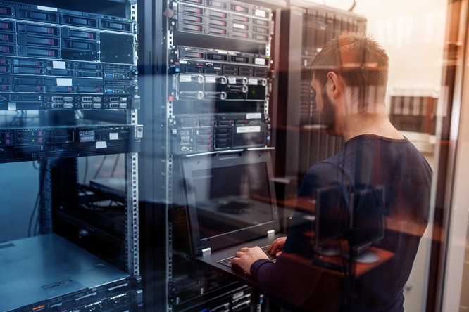 Network Engineer Working in Server Room