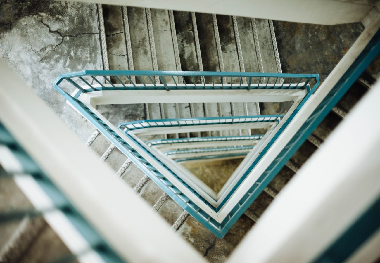 Long stair case with blue handrails