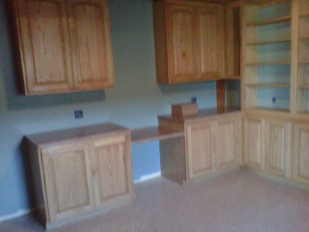 Office cabinets feature raised paneled doors,
 arched upper doors, adjustable shelves and desk. Colonial
 Maple hand wiped stain with clear coating finishes red oak wood.