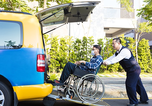 Driver Helping Man on Wheelchair