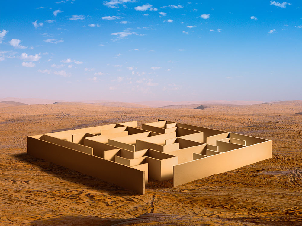 A photomontage of a giant maze in middle of desolate desert landscape, with paths in the sand leading to the maze's opening. 