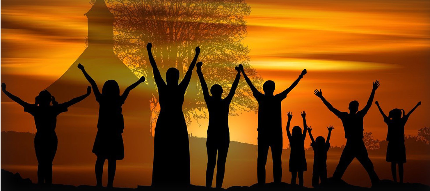 Silhouette of people worshipping in front of a silhouetted church Silhouette of people worshipping in front of a silhouetted church