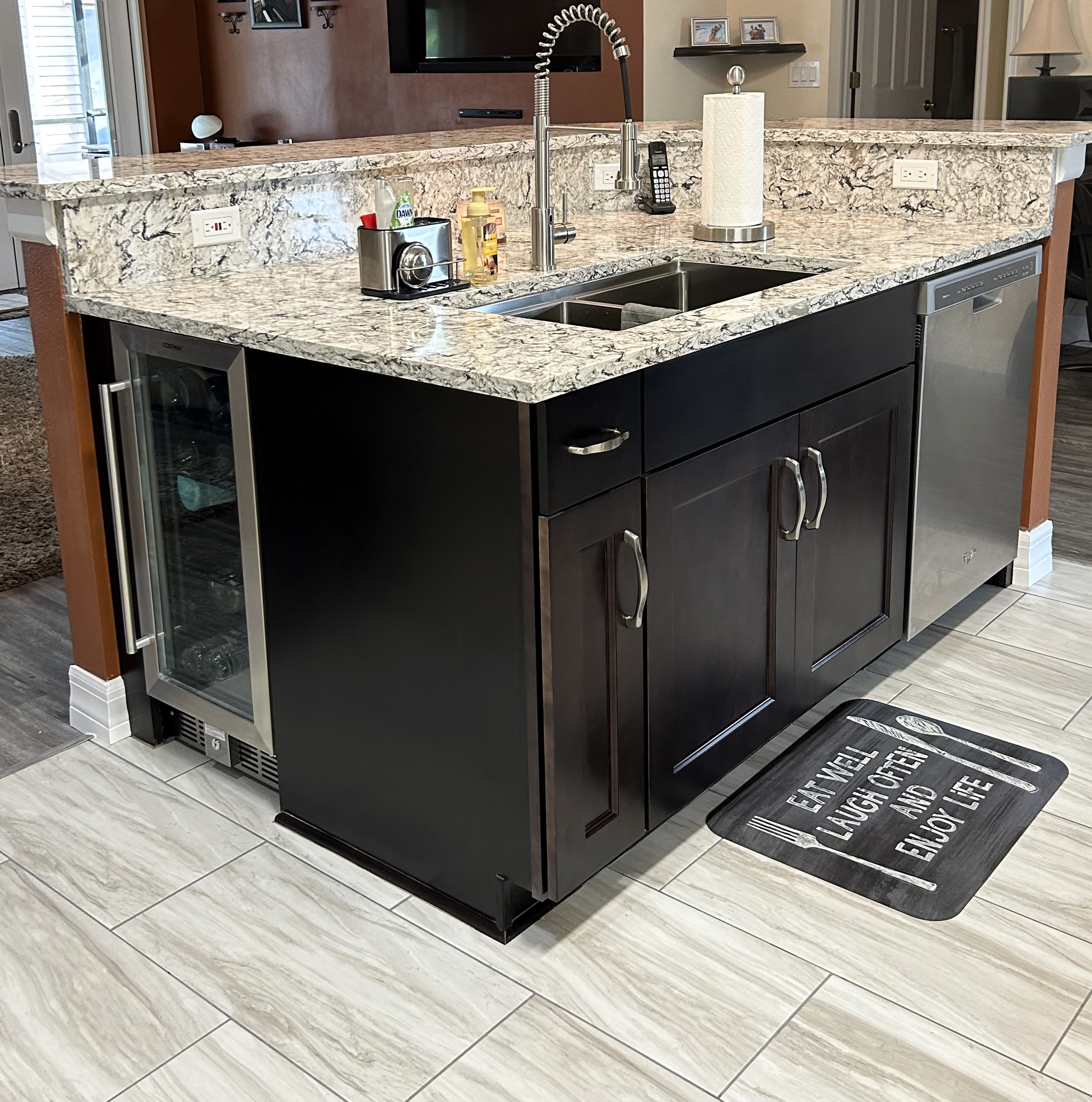 The Island features semi-custom maple chocolate-stained cabinetry with a convenient mini refrigerator on the end.