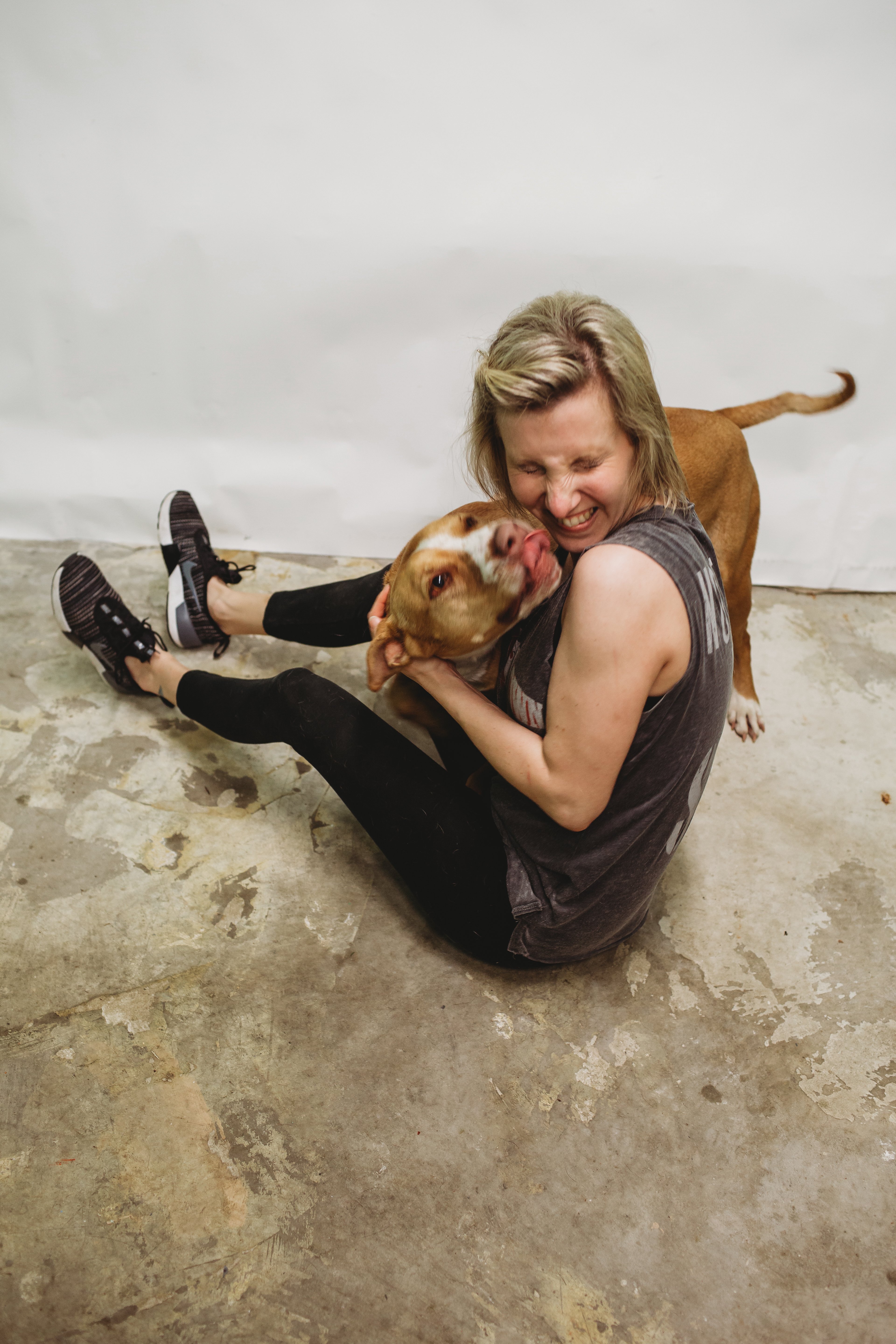 A large dog, licking a woman
