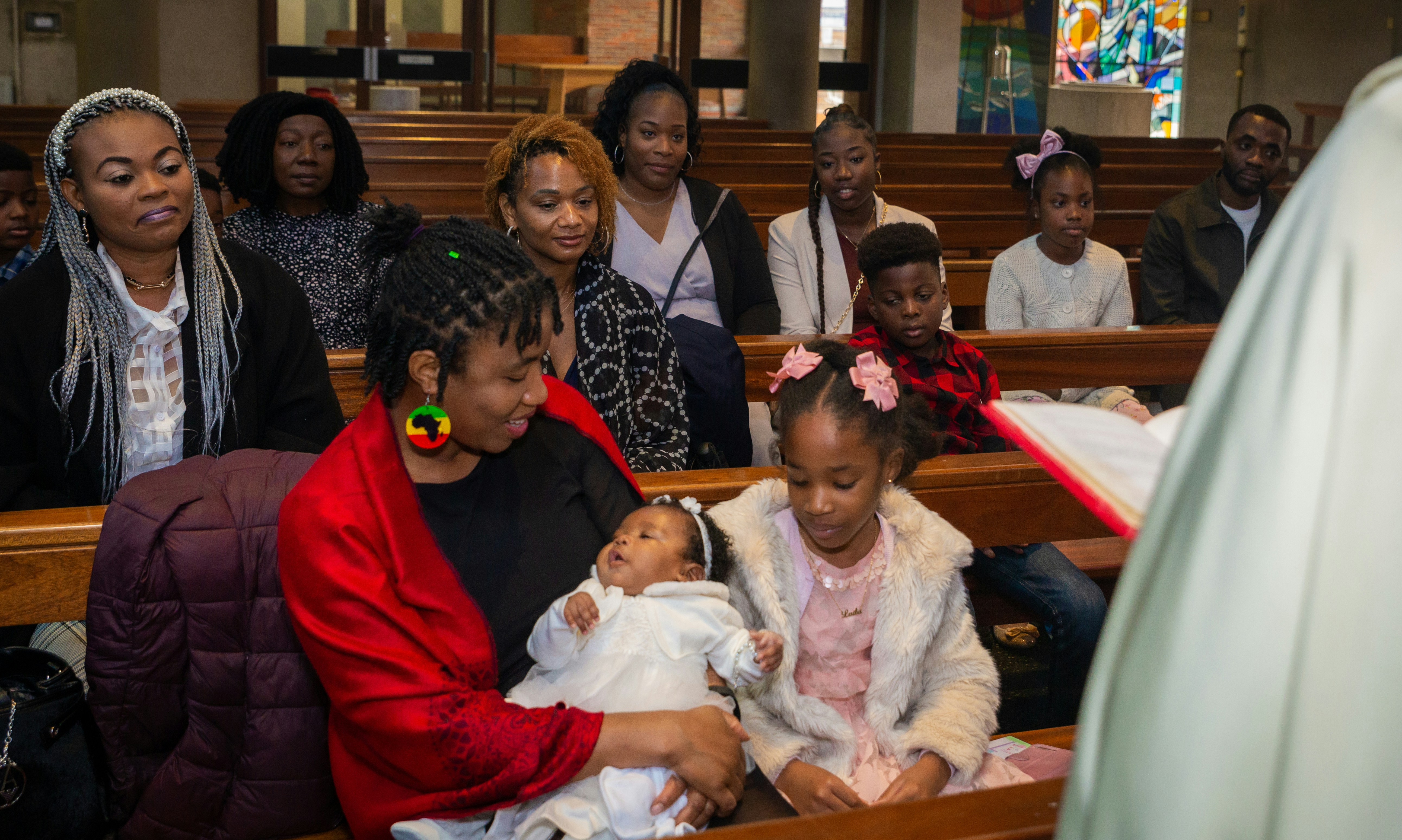 a group of people sitting in pews in a church