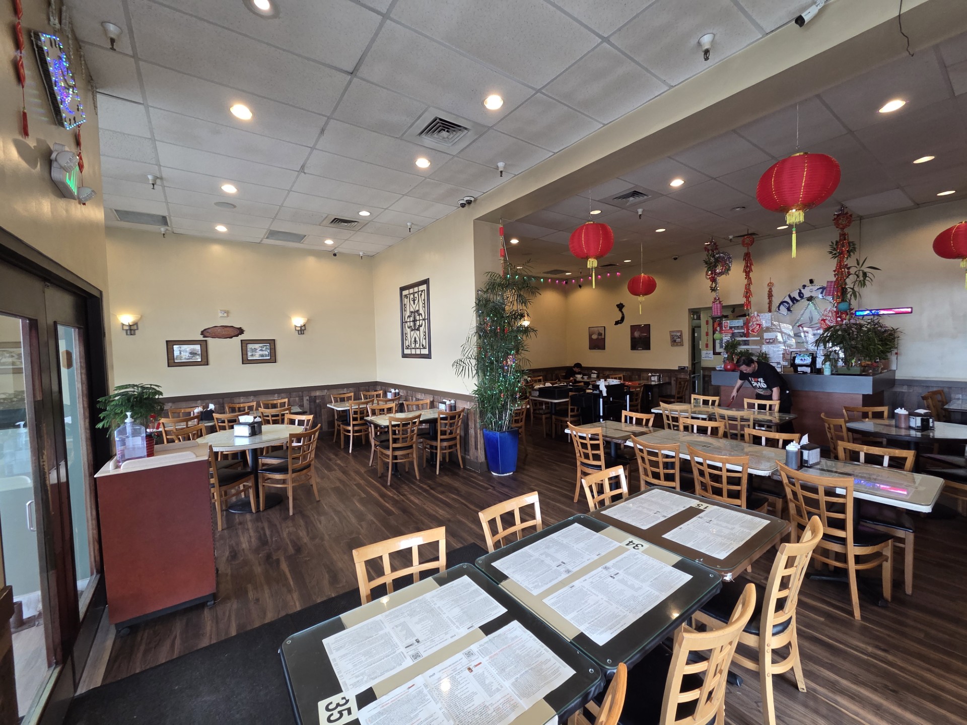 Purple taro bubble tea with boba pearls and a purple straw in a clear plastic cup.