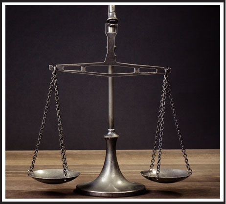 Law Scales on Table in Front Black Background