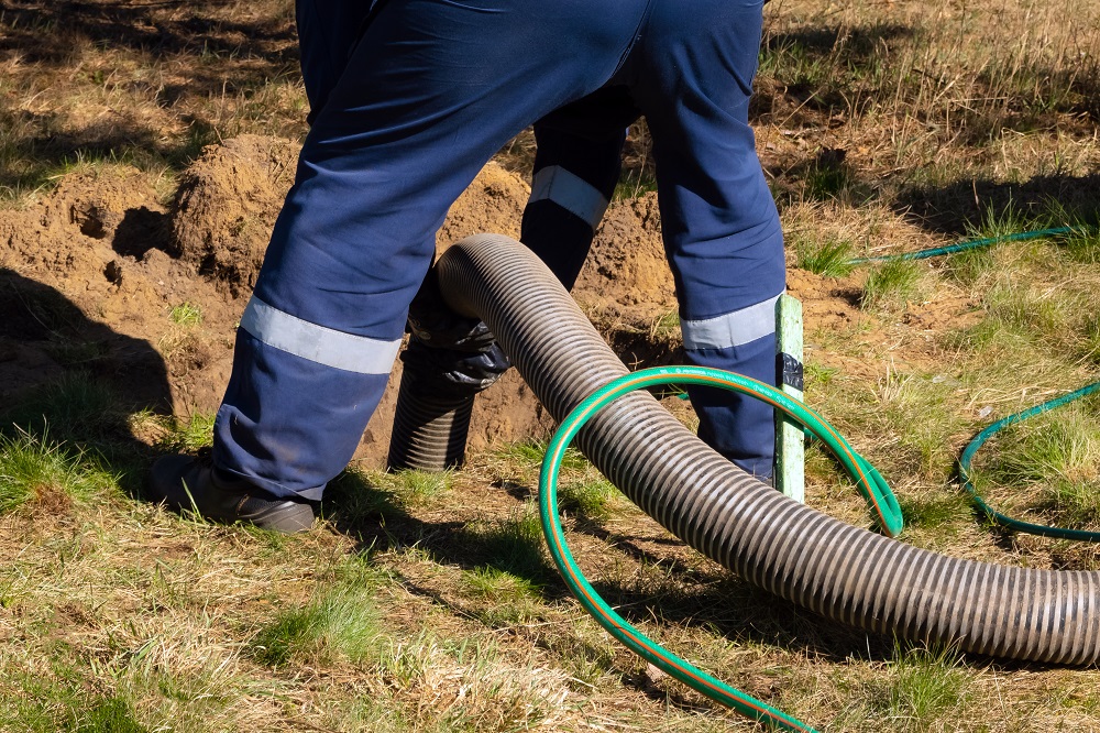 Man Draining Sewer Backup