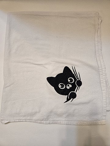 Flower sack towel featuring a peeking cat design