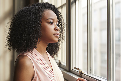 Woman Looking Out Of Window