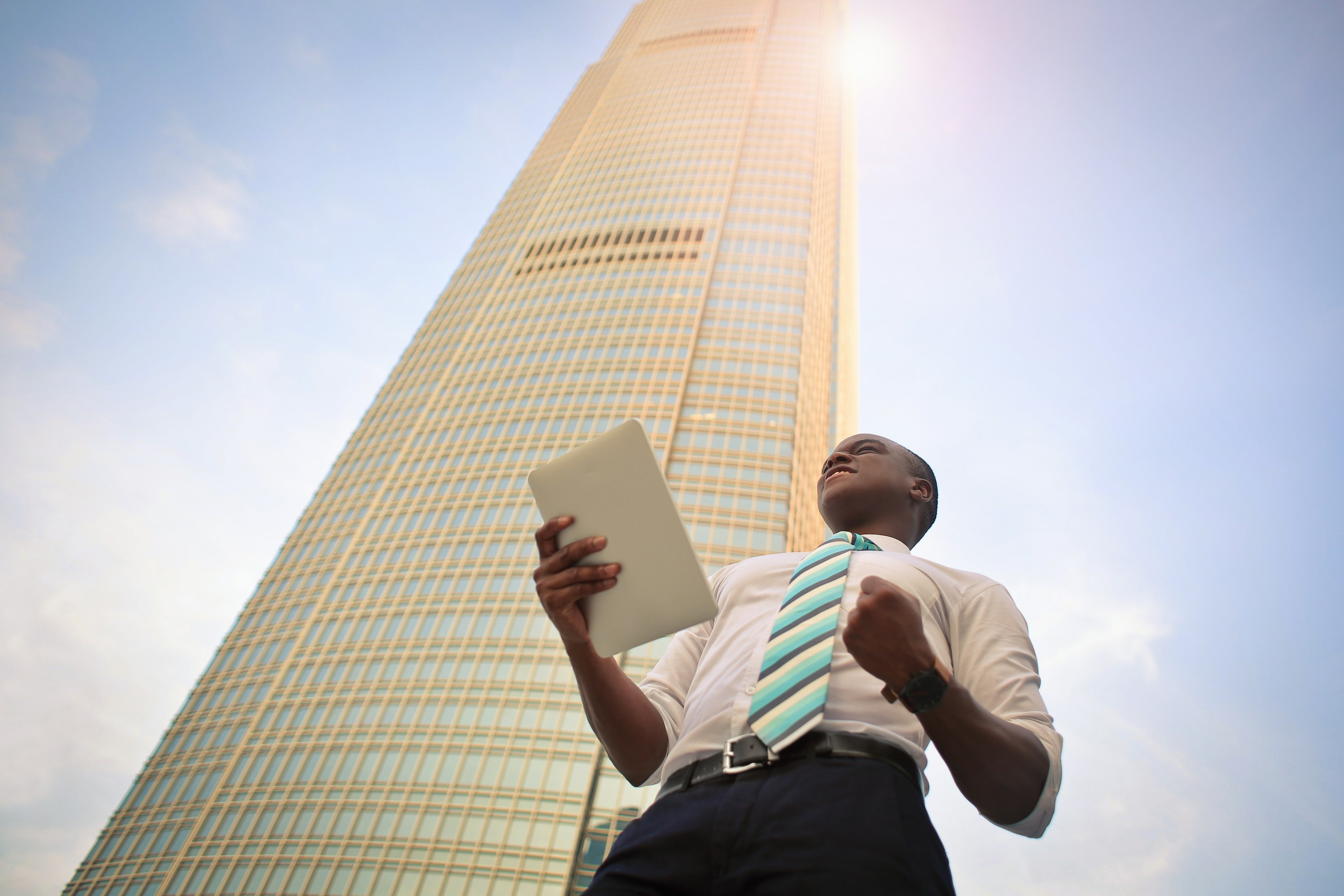 man standing near high-rise building
