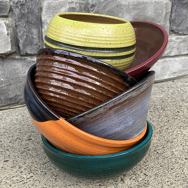 person making clay pot with brown powder