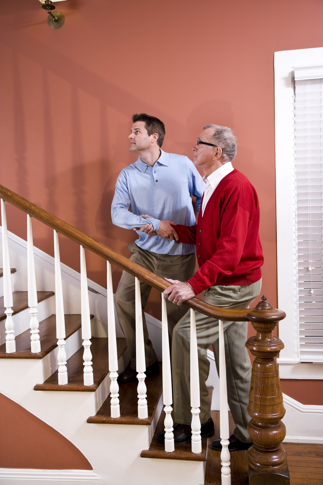 Caregiver Helping Old Man to Navigate Stairs
