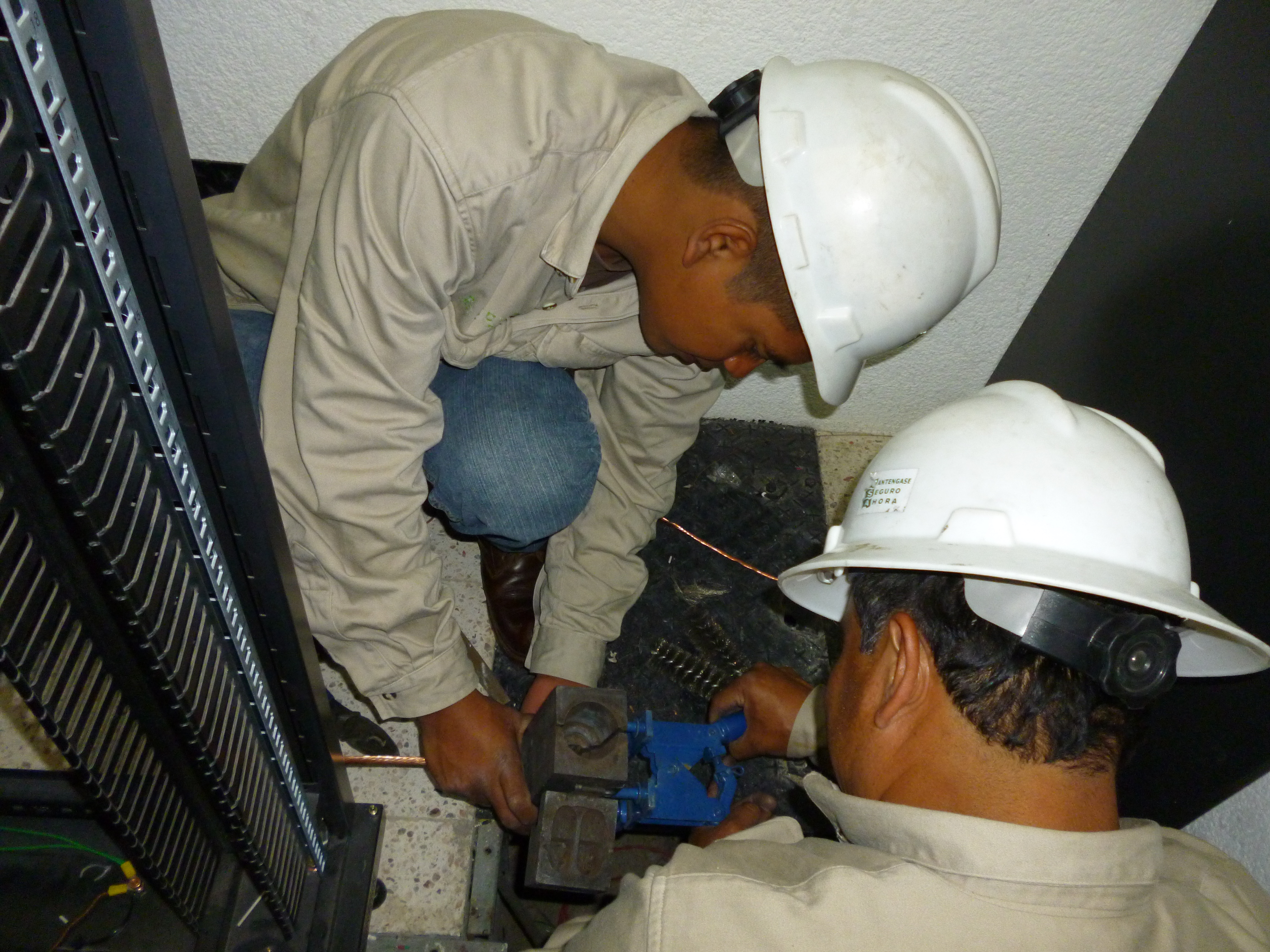 enchufe macho negro frente a enchufe eléctrico