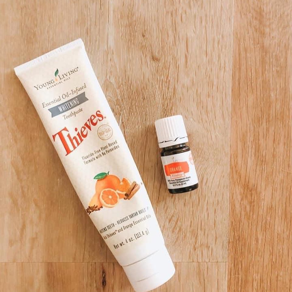 Thieves Whitening toothpaste with a drop of Orange Essential Oil