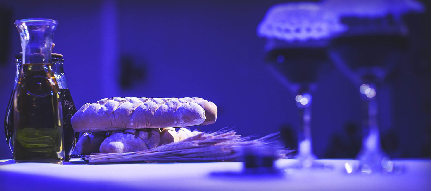 Holy supper on a table with blue lighting Holy supper on a table with blue lighting