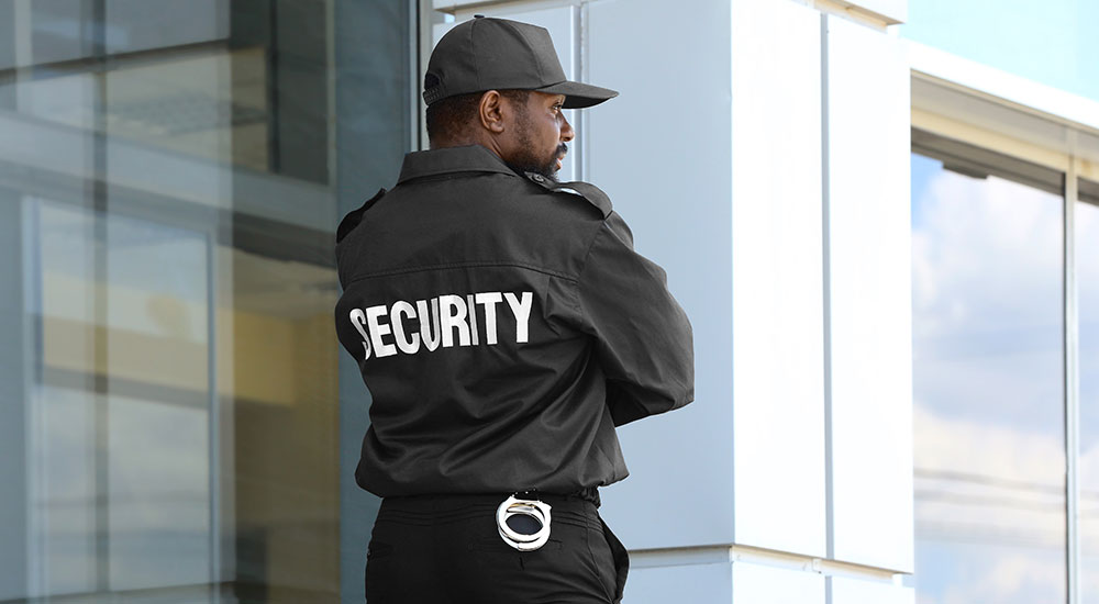 Security Guard Standing Near Big Modern Building